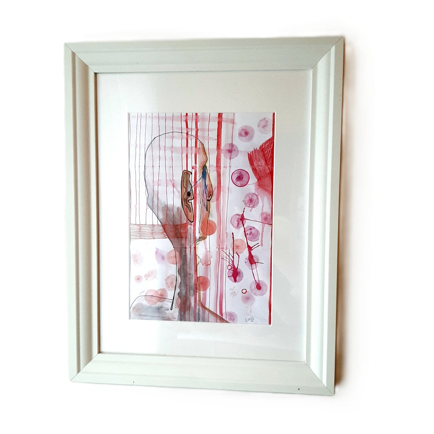 Framed abstract artwork with red and pink tones on a white background